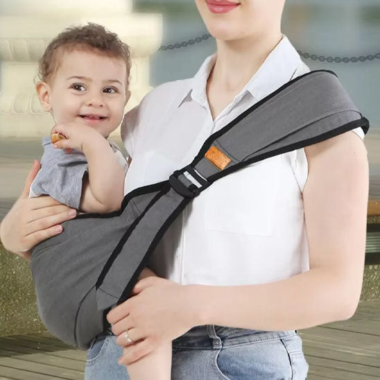 Porte bébé Luminid™ - Gris pâle confortablement assis contre maman